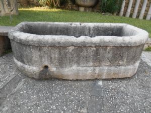 Large antique fountain in bush-hammered white marble